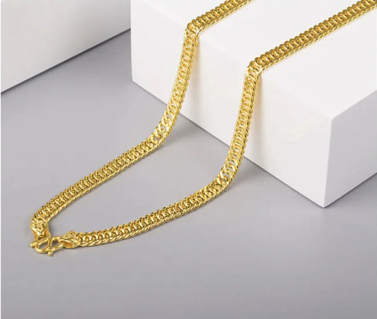 A gold-plated men's necklace laid out on a white surface, showcasing its thin and classic design.